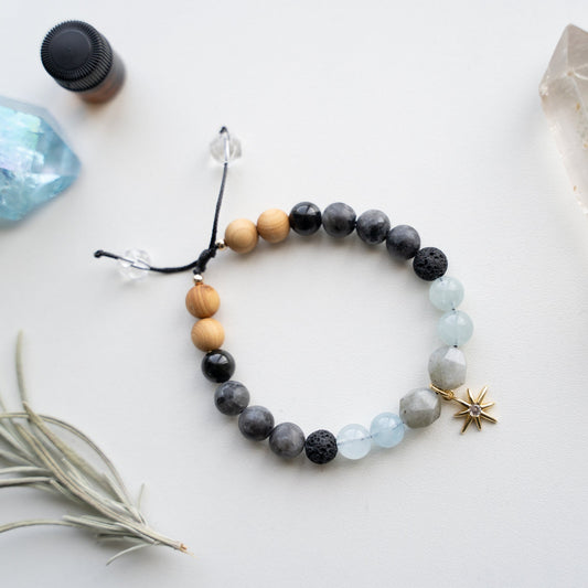 Spirit of the Woods Gemstone Bracelet Collection. The cosmic protection Bracelet is hand-knotted with 8mm semi-precious AAA grade beads. One-of-a-kind jewelry. Labradorite, Aquamarine, Larvikite, Tourmaline, Crystal Clear Quartz, Lava Rocks and gold accents. Perfect for a Goddess!